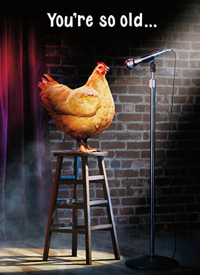 front of card is a photograph of a chicken on stool on a stage at a microphone with front text