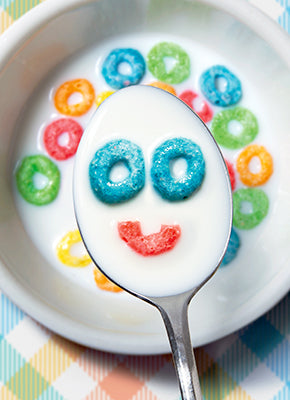 front of card is a photograph of a cereal in a spoon making a smile face out of the  cereal pieces