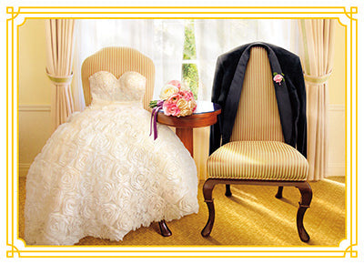 front of card has two chairs one wearing a wedding dress and the other with a tux