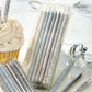 packages of silver glittered candles, cupcake, and confetti on table.