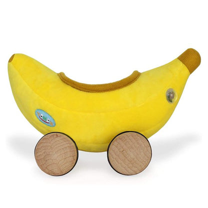 plush banana car with wooden wheels on white background.