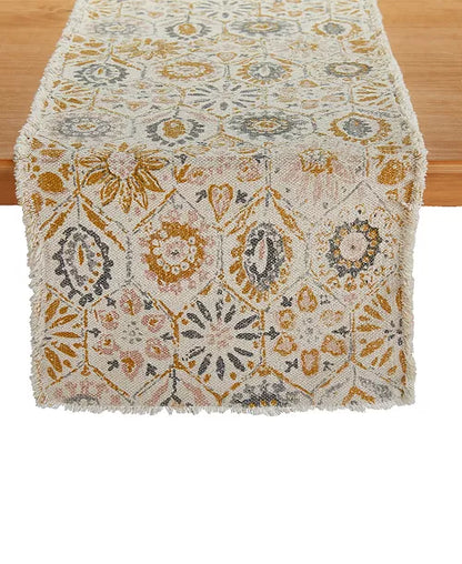 table runner with geometric and floral design hanging over edge of table.