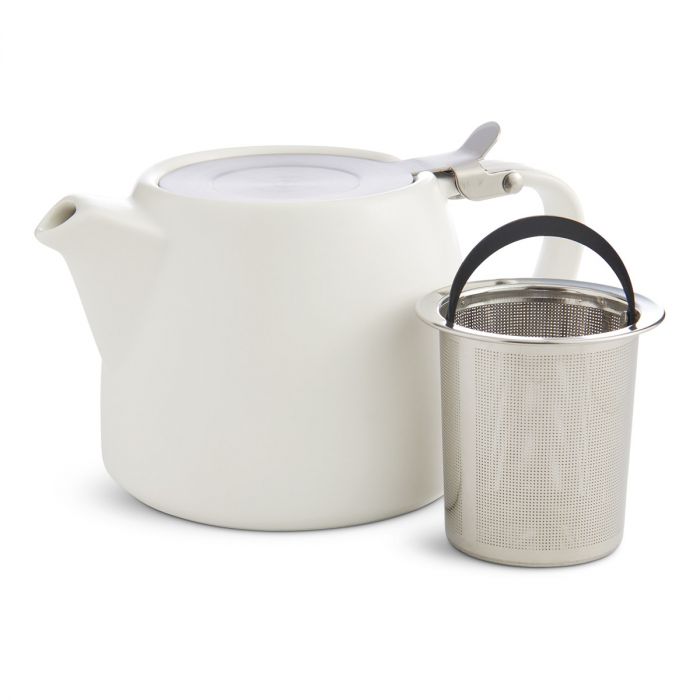 metal infuser sitting next to the white unity teapot on a white background