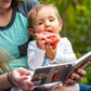 woman holding baby and reading fox book.