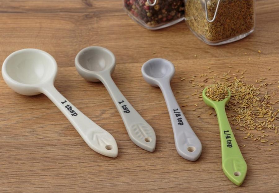 measuring spoons and spices on wooden countertop.