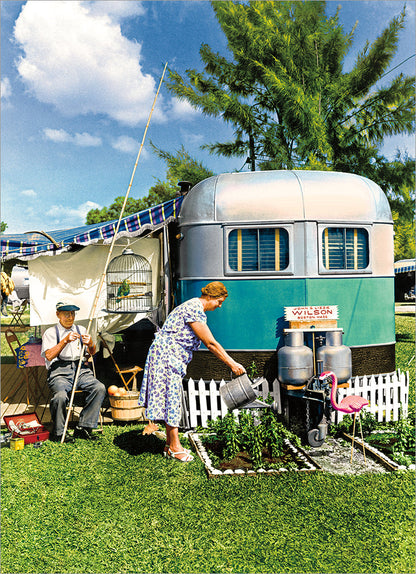 front of card has picture of a camper set up with a woman watering her garden with a man preparing a fishing pole
