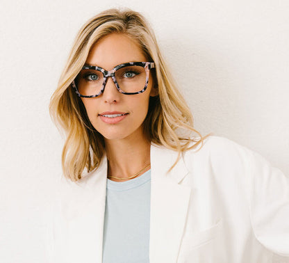 front view of a woman modeling the black marble next level glasses against a white background