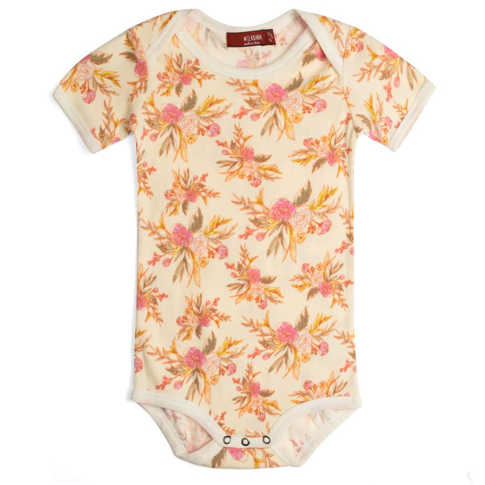 vintage floral cotton one piece is light pink with pink roses and gold leaves all over displayed on a white background