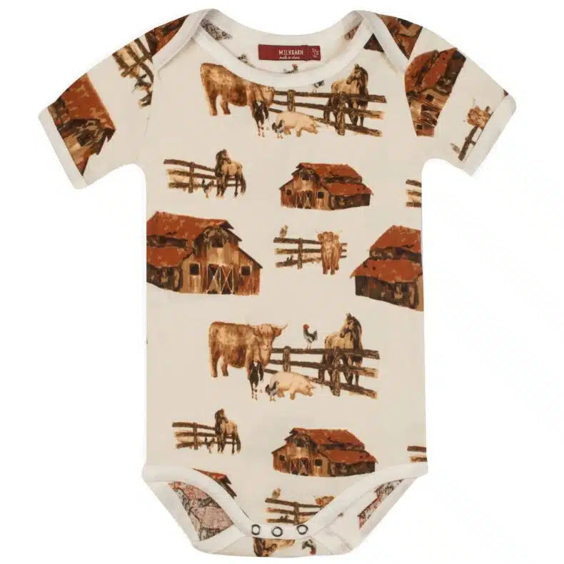 cream onsie with all-over pattern of barns, horses, and cows.