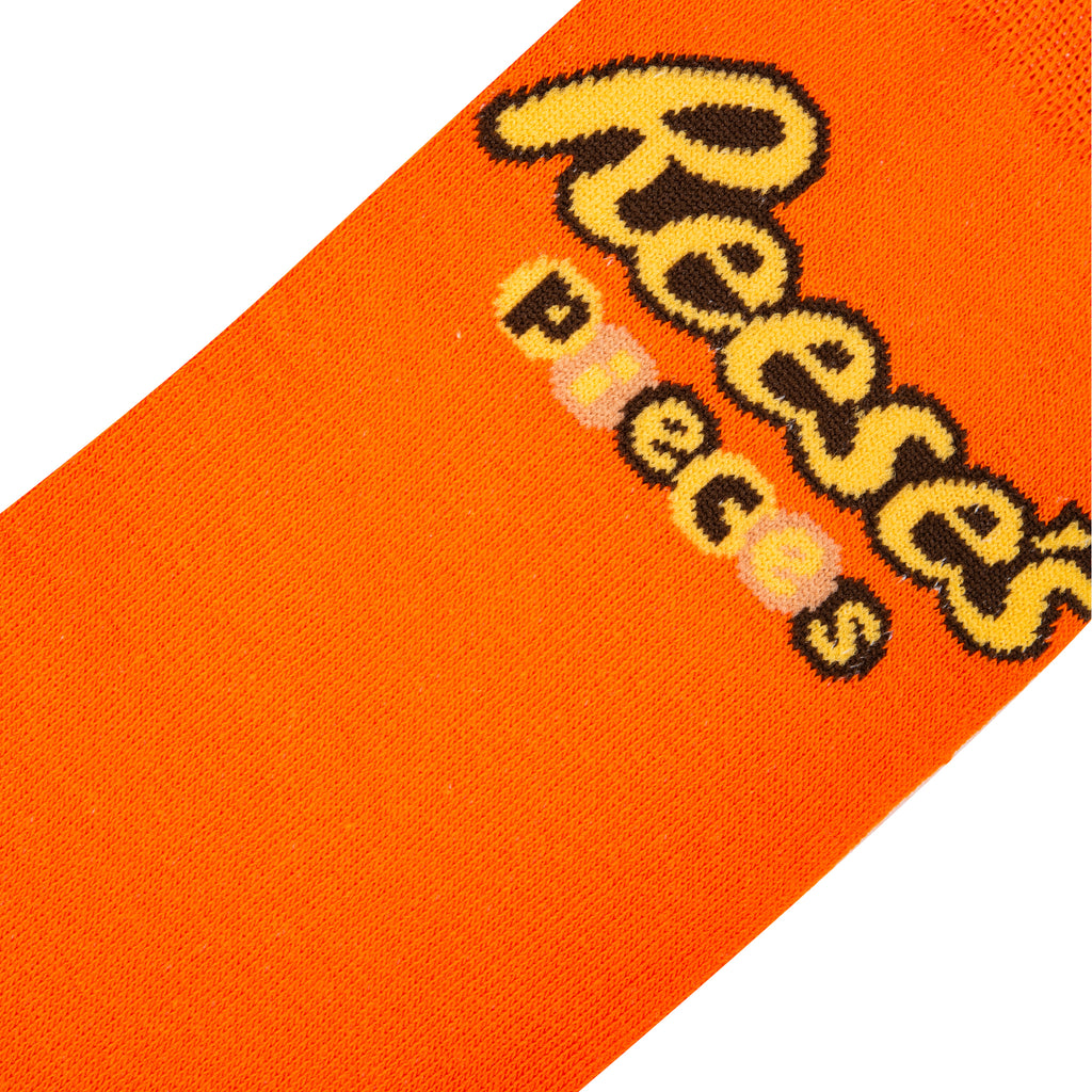 close up view of reeses pieces crew socks displayed flat on a white background