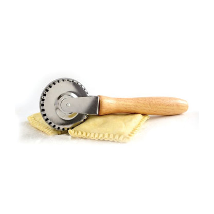 side view of pastry crimper with fresh ravioli.