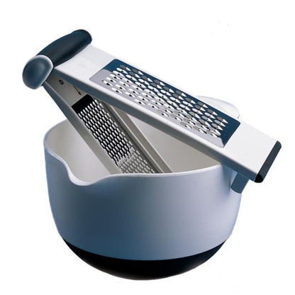 multi grater displayed on a white bowl against a white background