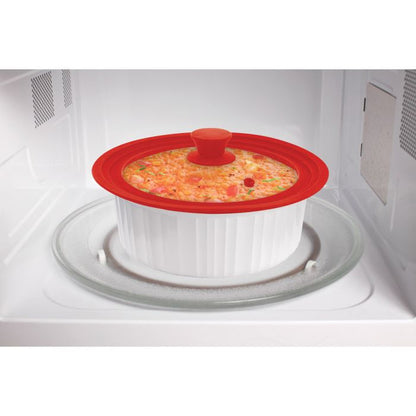 universal pot lid displayed on a white dish that is sitting inside a microwave