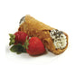 strawberries next to cannoli filled with cream.