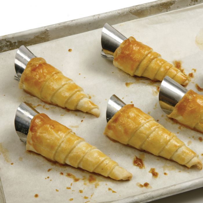 Stainless Steel Cream Horn Molds wrapped in baked pastry dough.