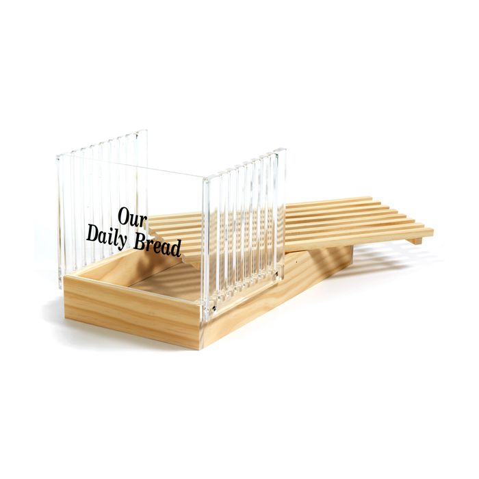 wooden tray with acrylic slicing guide printed with text "our daily bread".