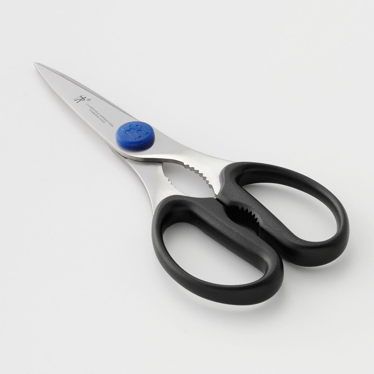 angled view of the take apart kichen shears displayed on a light gray surface