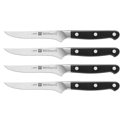 set of four steak knives with rivet black handles on white background a