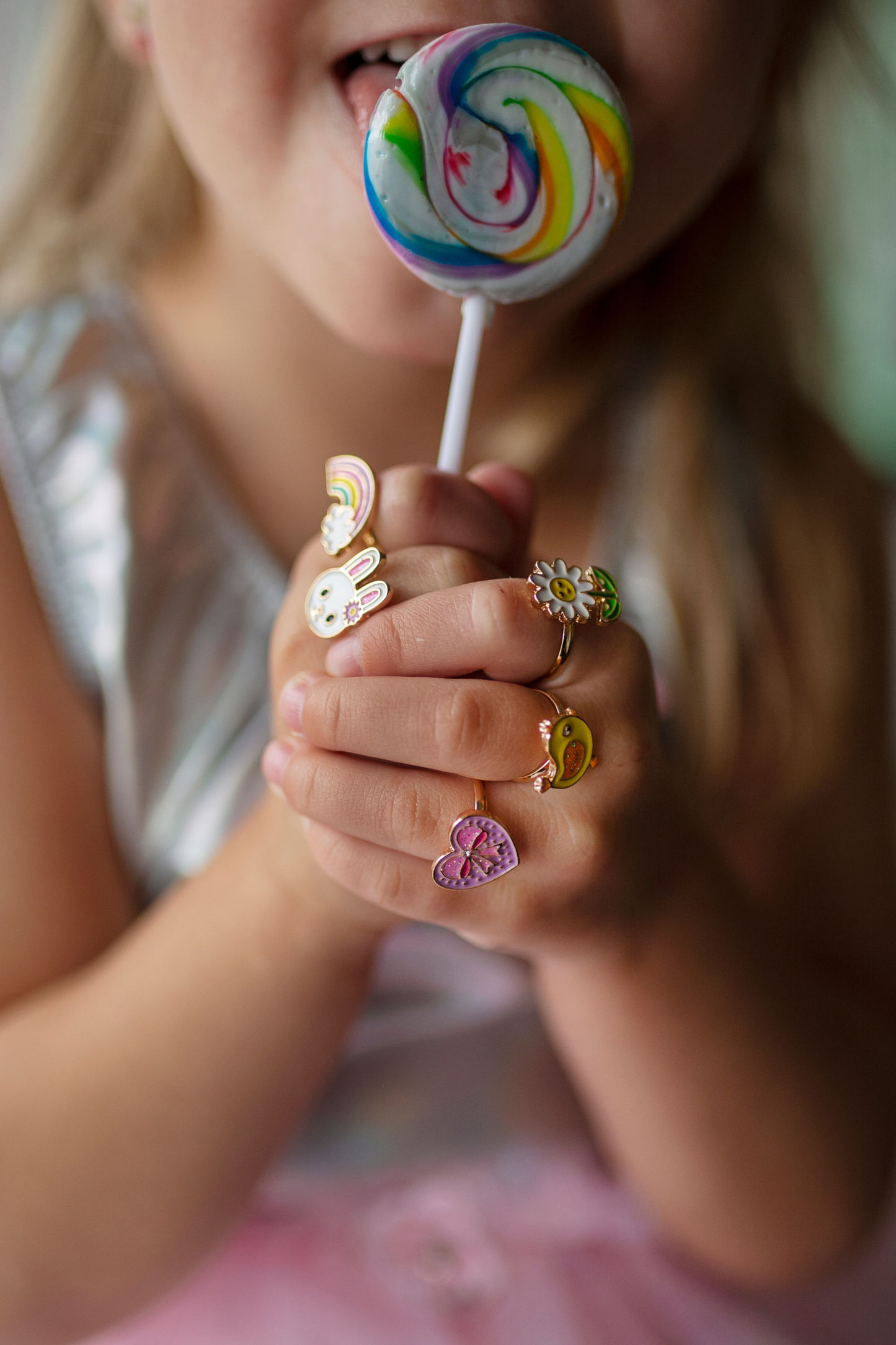 a little girl wearing the spring flower ring set while holding a sucker