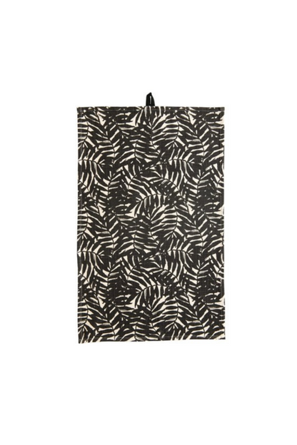 cream dishtowel with black palm leaf design.