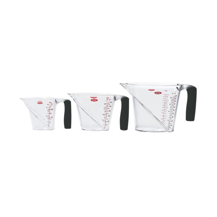 small, medium and large measuring cup with pouring spouts, black handles, and red markings.