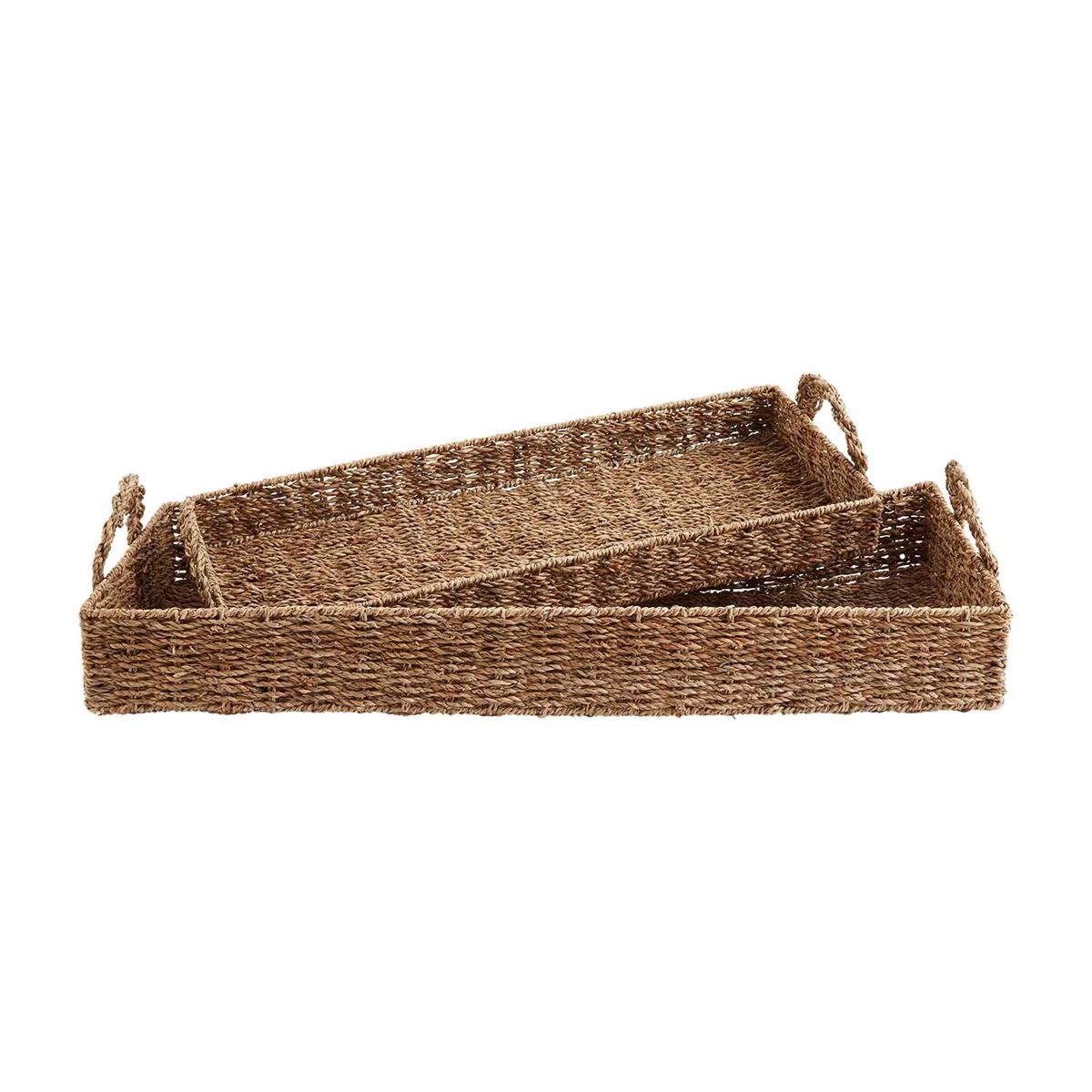small and large seagrass basket trays displayed on a white background