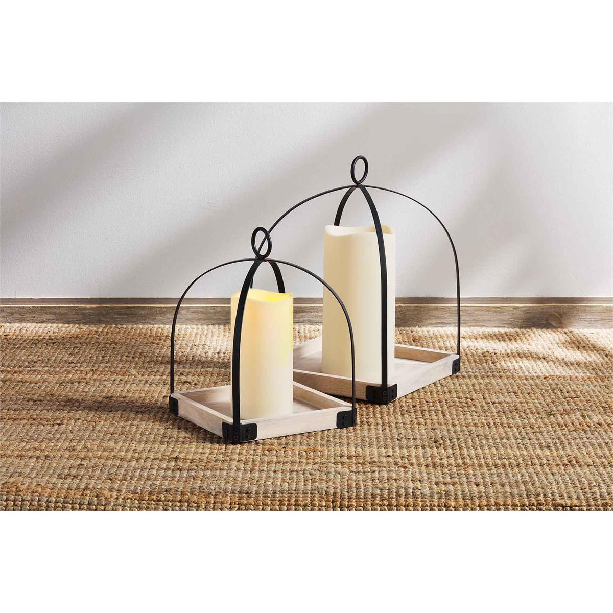 small and large iron lanterns displayed on a natural woven table runner