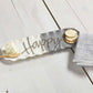 happy hostess set displayed next to a folded towel with crackers and cheese ball on a light gray wood slat surface
