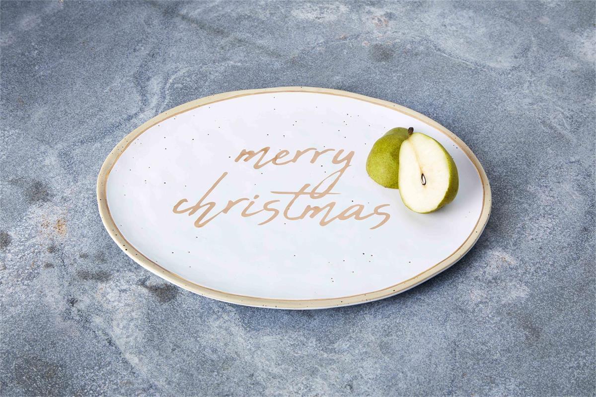 oval ceramic platter with "merry christmas" painted in gold in the center and pear halves set on it.