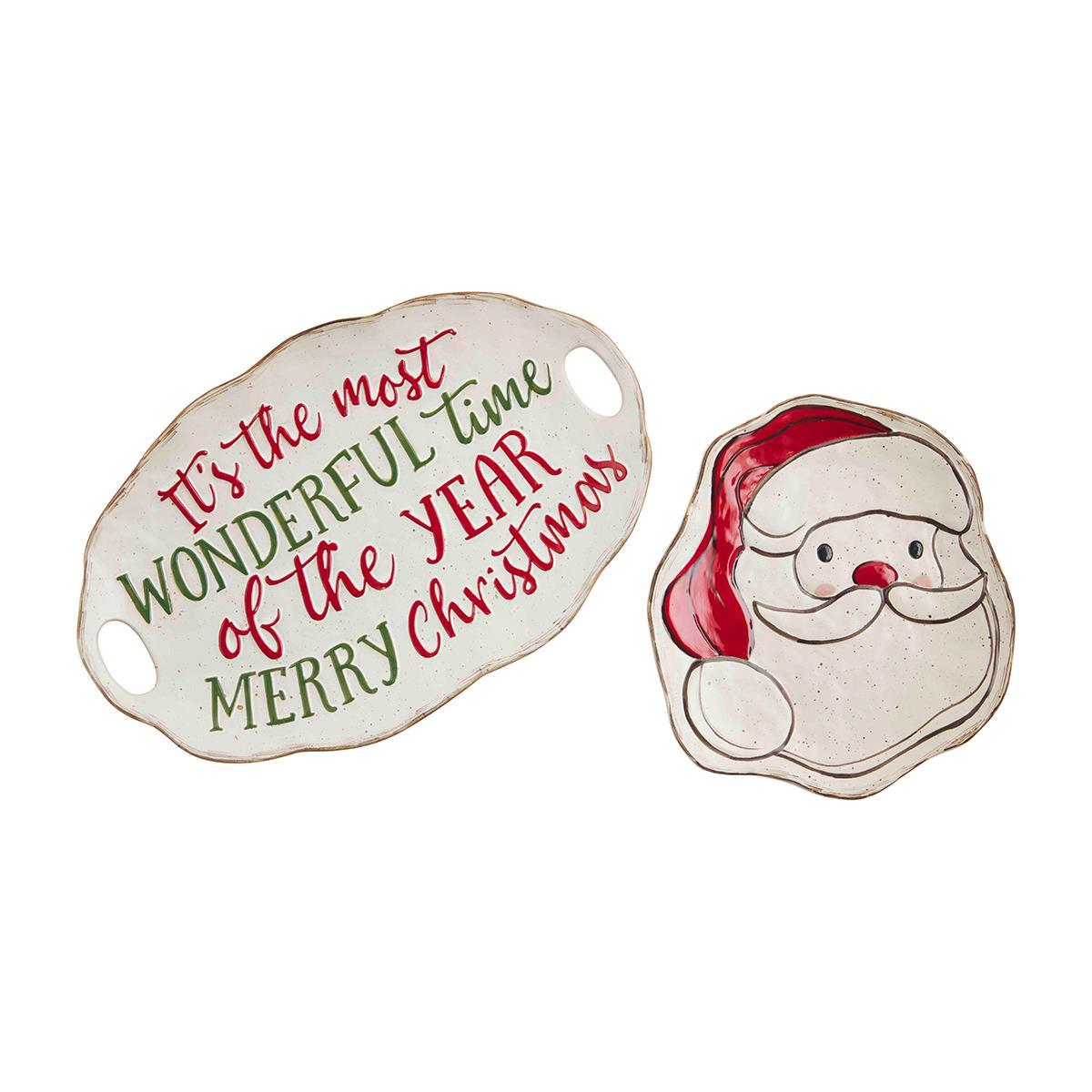 large ceramic oval platter sentiment in red and green script lettering with handles and a ceramic santa face shaped platter on a white background