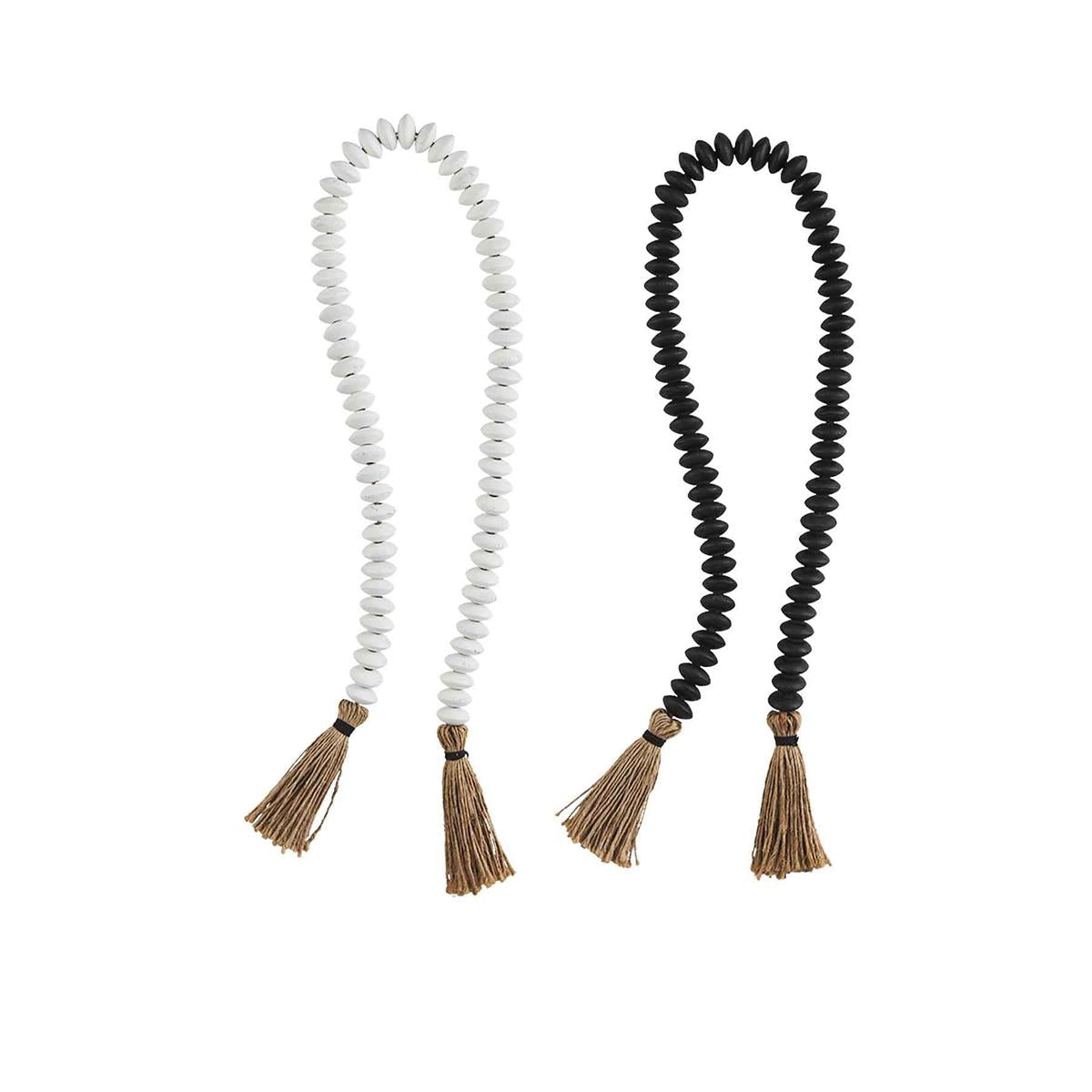 one white and one black tassel decor beads on white background
