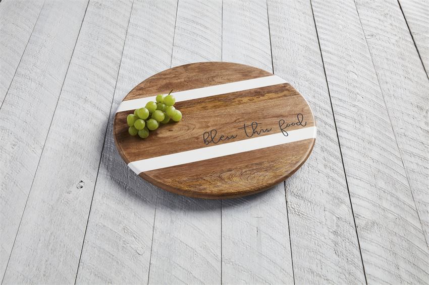 bless this food lazy susan displayed with grapes on an light gray wood slat table
