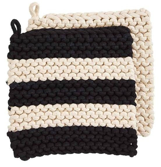 over lapping crocheted pot holders, one is solid cream, the other is black and cream striped.
