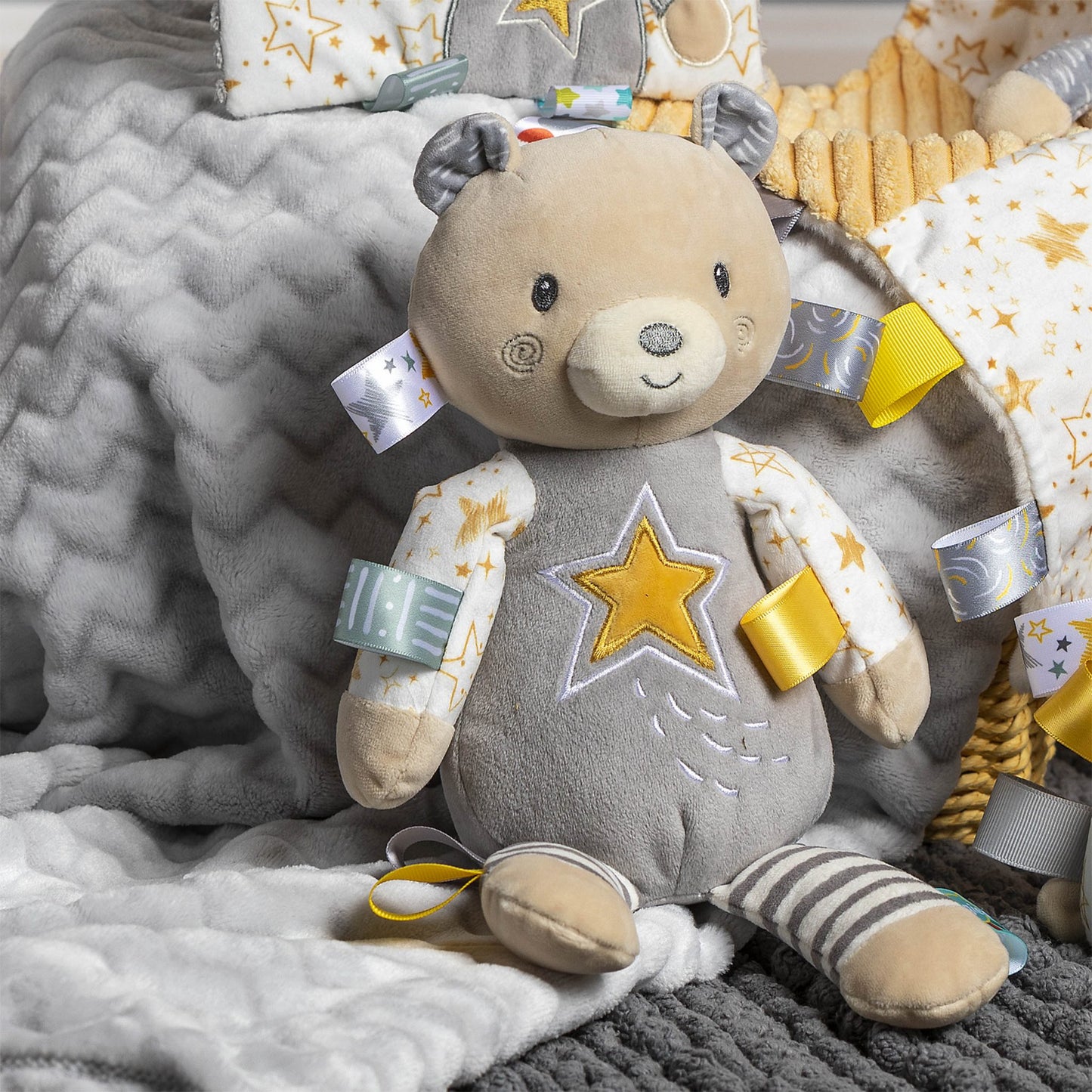 be a star soft toy displayed on multiple gray blankets in different shades of gray