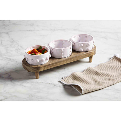 beaded dip bowl and stand set displayed on a white and gray marble countertop next to a tan towel