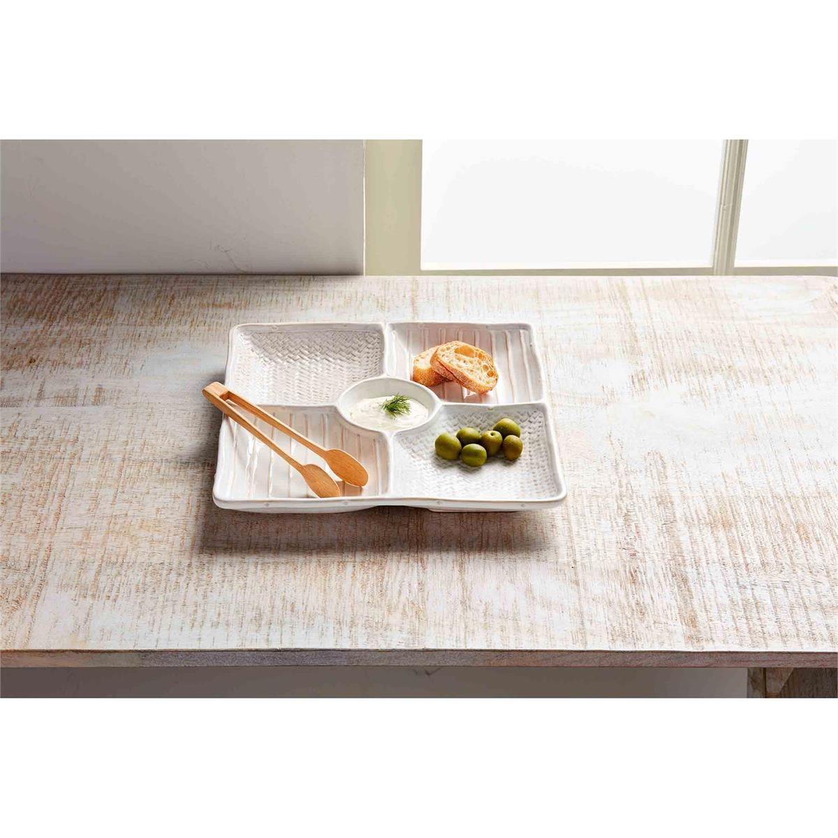 textured sectioned server set displayed on a whitewashed wooden surface next to a window