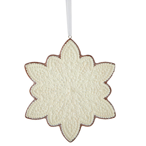 ornament shaped like a snowflake and decorated like a cookie with white icing.