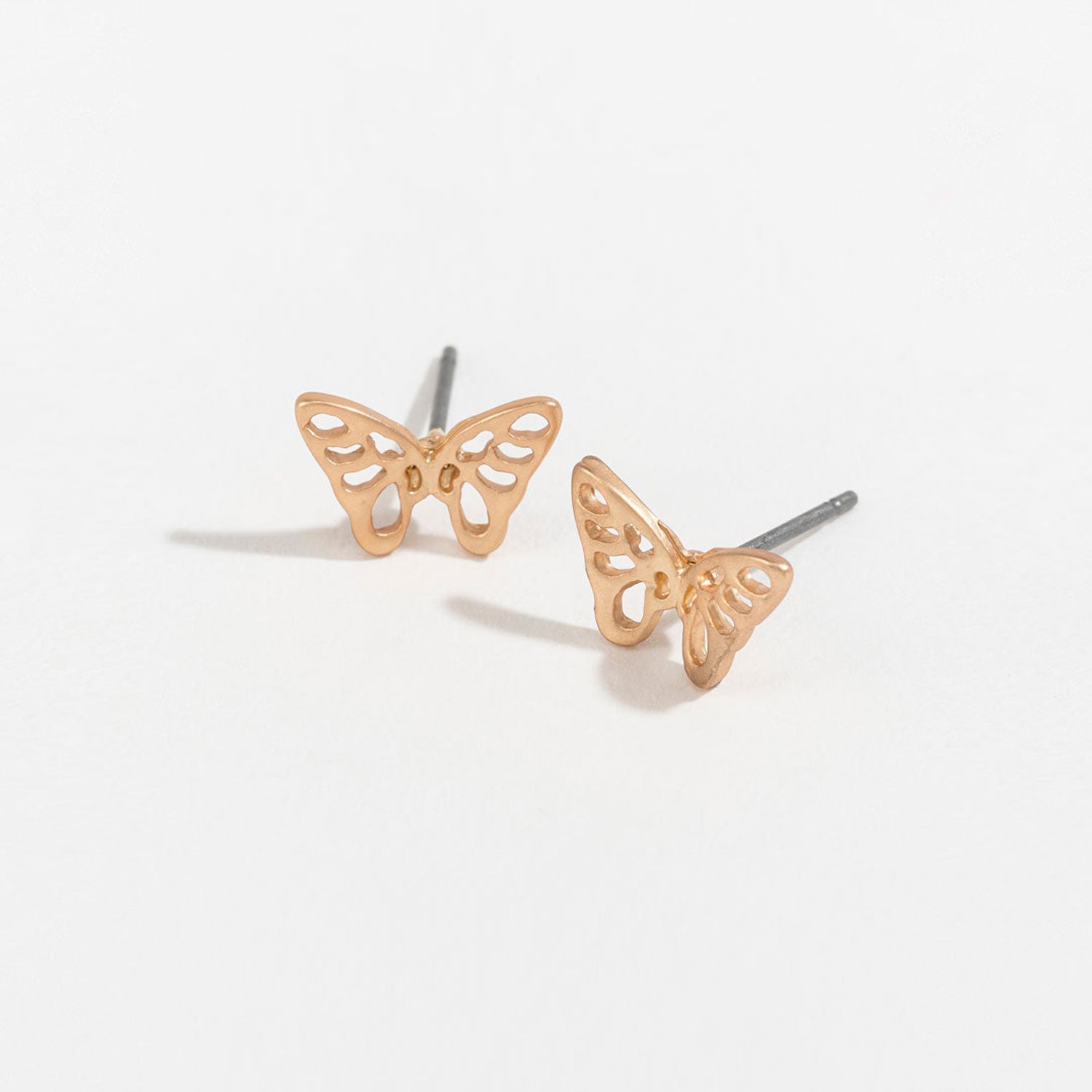gold butterfly stud earrings on a white background