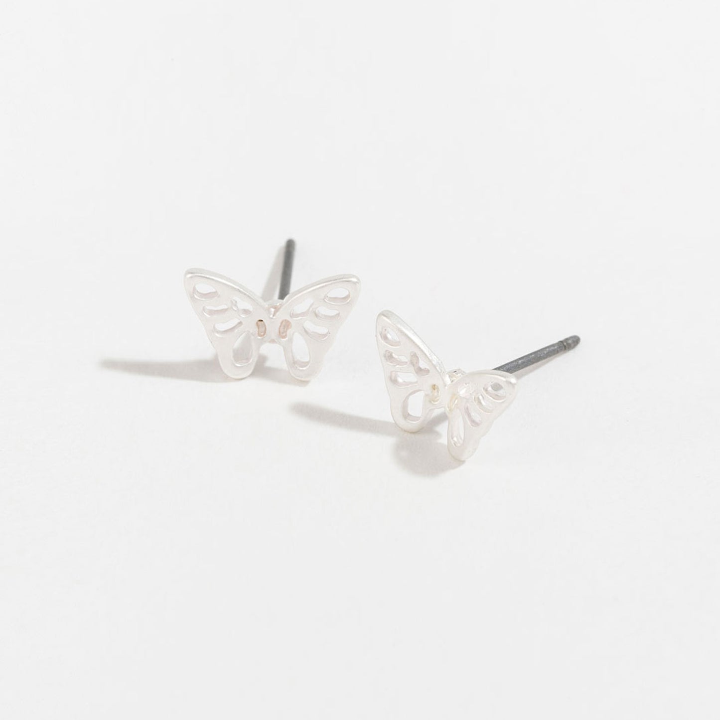 silver butterfly stud earrings on a white background