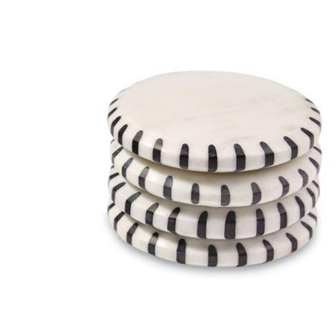 black and white ticking marble coasters stacked on a white background