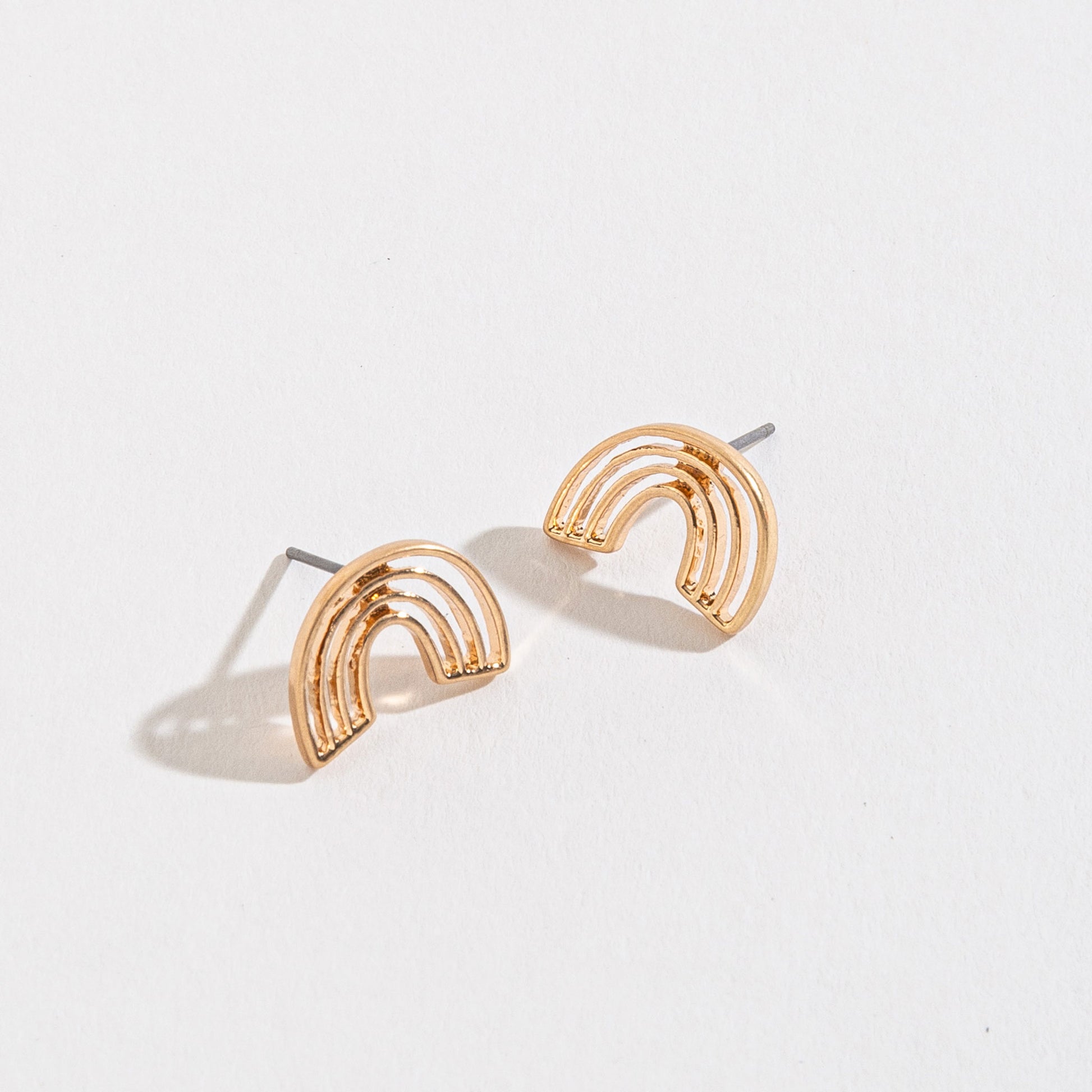 gold rainbow stud earrings on a white background