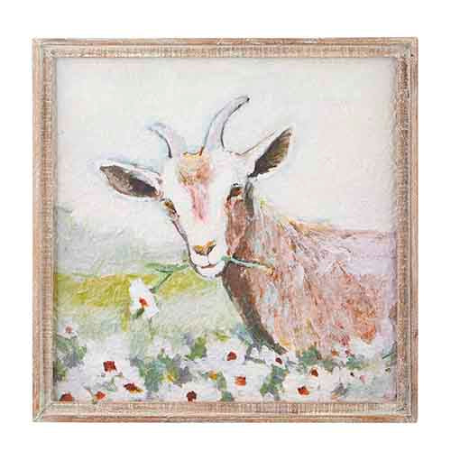 print of goat in meadow with flower stem in its mouth with a wooden frame.