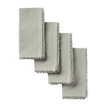four grey napkins spread out on a white background