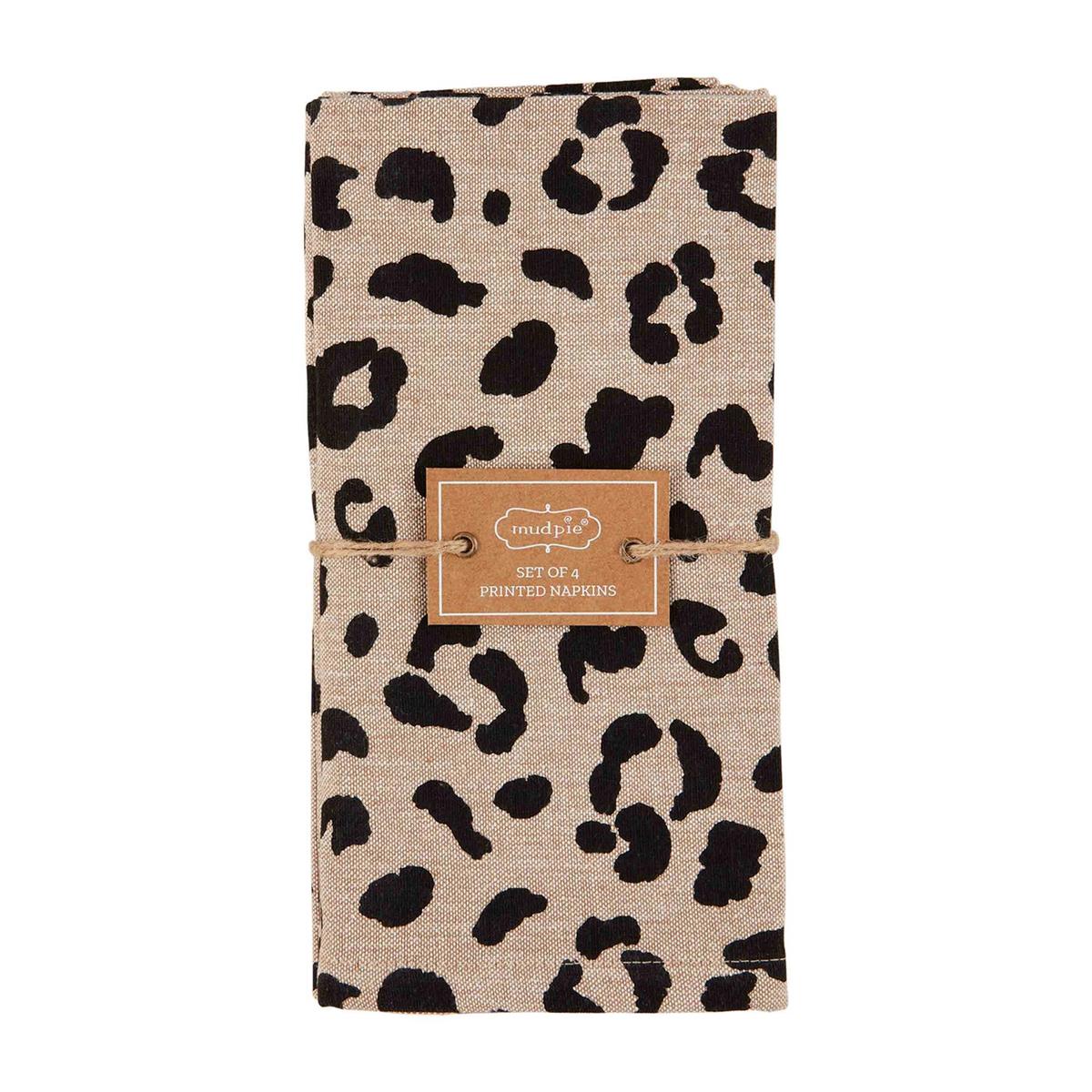 tan and cheetah print napkins folded and tied with twine on a white background