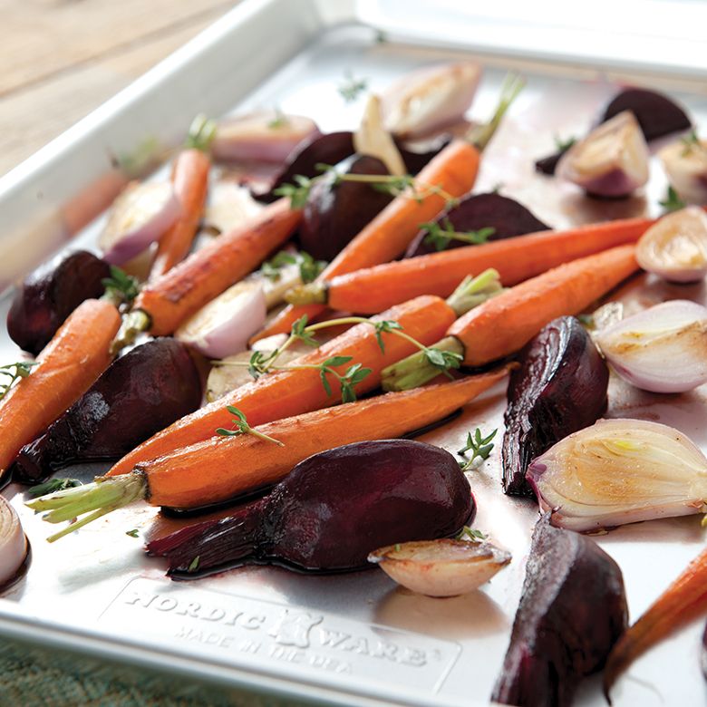 large baking sheet filled with roasted carrots and onions.