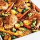 large baking sheet filled with roasted chicken and veggies.
