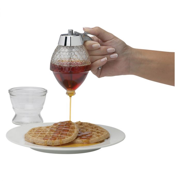 illustration of a person's hand releasing syrup on to a plate of waffles on a white background