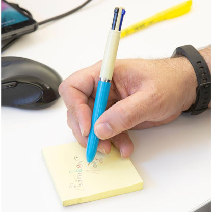 a person writing with the blue vintage multi pen on a yellow sticky notes next to a computer mouse on a white surface