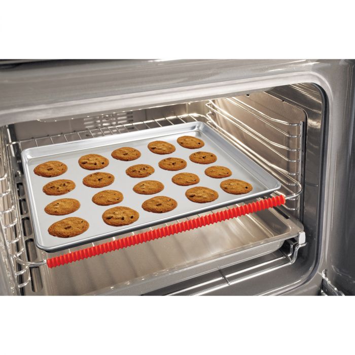 a oven rack shield displayed in a oven with a baking sheet of cookies