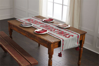 reversible tartan table runner displayed on a rustic dark wood table with white plates and plaid napkins